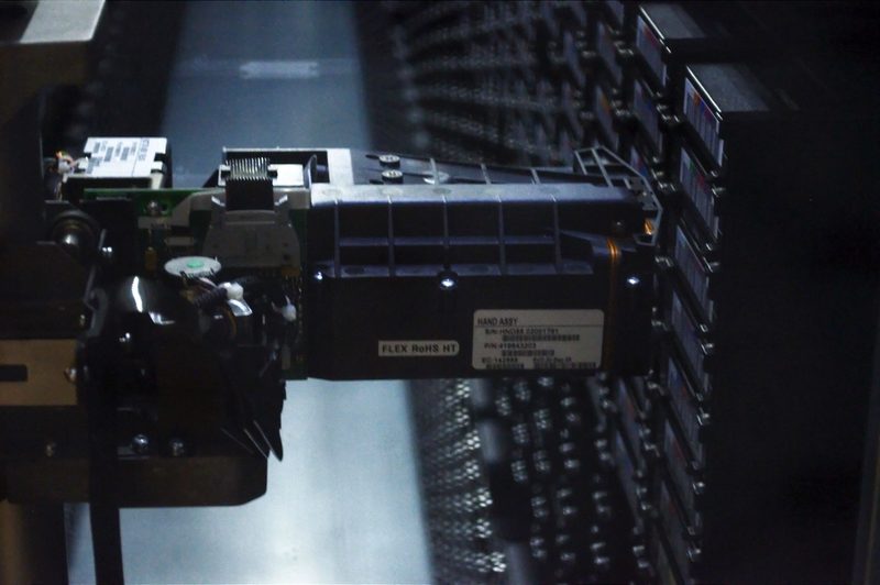 Industrial robotic arm handling tape cartridges
