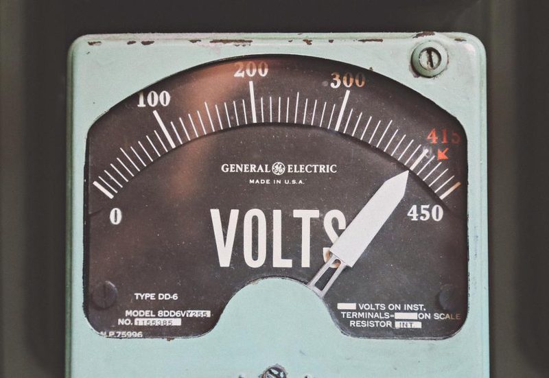 Digital electricity meter showing live power readings